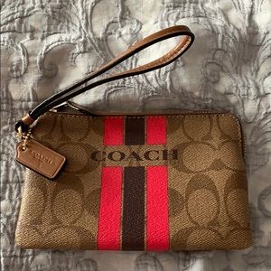Brown coach wristlet with pink and dark purple